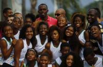 Jamaican Olympic gold medallist Usain Bolt poses with youths at the Mangueira slum Olympic center, ahead of the "Mano a Mano" challenge, a 100-meter race, in Rio de Janeiro, Brazil, April 16, 2015. REUTERS/Ricardo Moraes/File Photo