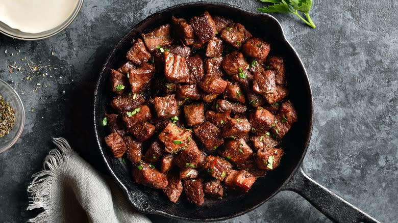 cubed meat in cast-iron skillet