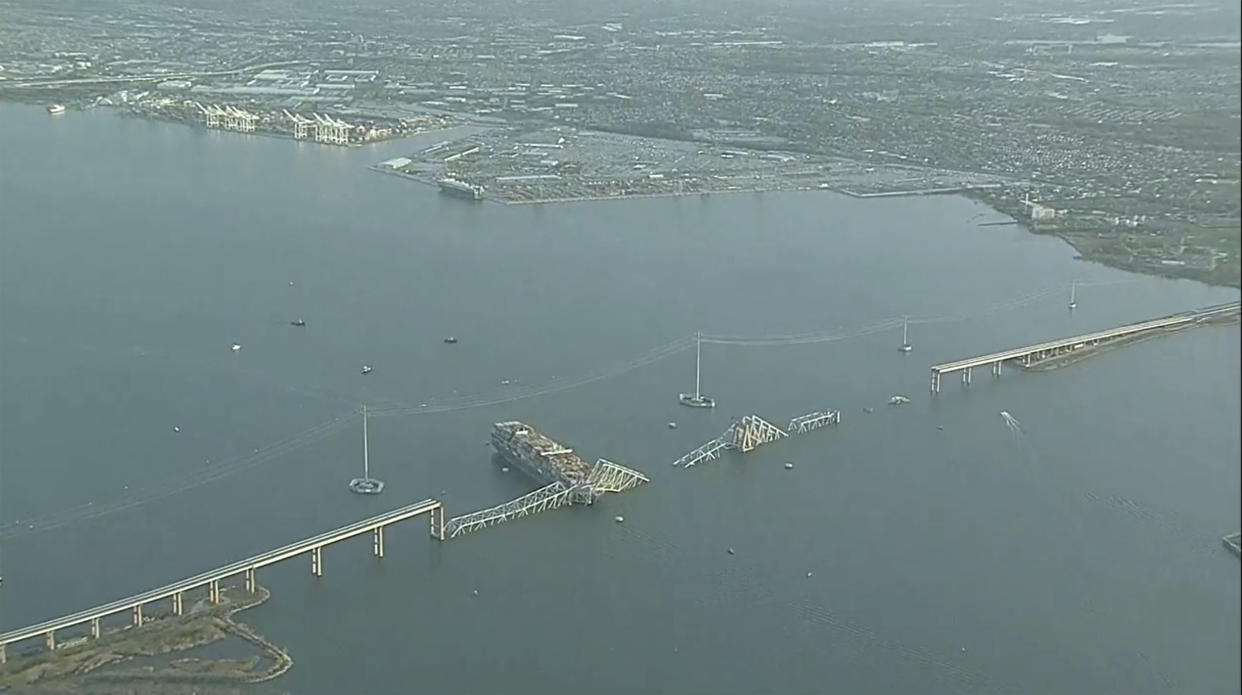 Parts of the Francis Scott Key Bridge remain after a container ship collided with a support Tuesday, March 26, 2024 in Baltimore. The major bridge in Baltimore snapped and collapsed after a container ship rammed into it early Tuesday, and several vehicles fell into the river below. Rescuers were searching for multiple people in the water. (WJLA via AP)