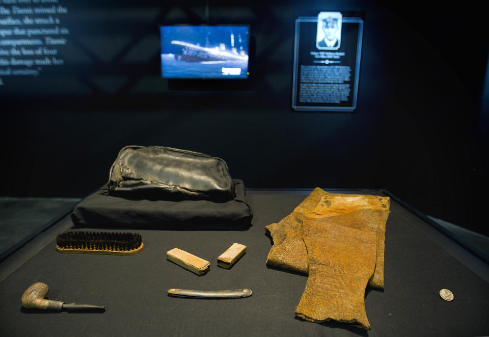 The personal effects of William Murdoch, the bridge officer aboard the Titanic, sit on display before an exhibition opens to the public Tuesday, April 3, 2012, in Atlanta. From the pitch-black depths 2½ miles beneath the North Atlantic, salvagers of the Titanic made a notable discovery when they located the personal effects of Murdoch, the bridge officer who tried in vain to keep the doomed ship from colliding with an iceberg. The artifacts, including a shoe brush, straight razor and pipe, are the first to be specifically to Murdoch, a central figure in the disaster who gained added notoriety after James Cameron’s polemical portrayal of him in the 1997 blockbuster movie “Titanic.” (AP Photo/David Goldman)