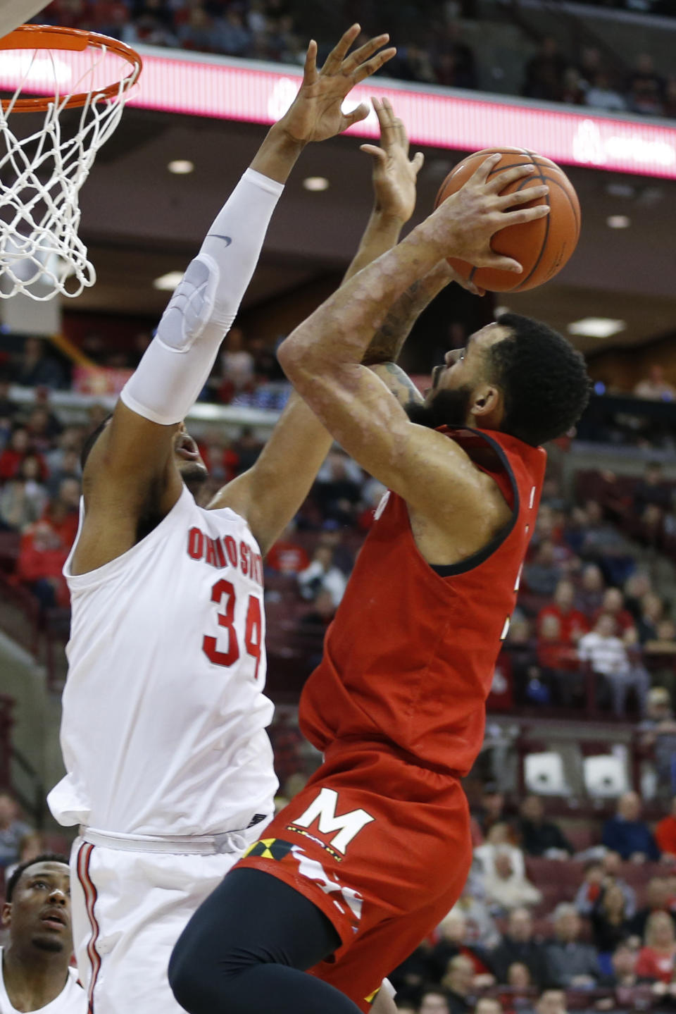 Maryland's Eric Ayala, right, shoots over Ohio State's Kaleb Wesson during the first half of an NCAA college basketball game Sunday, Feb. 23, 2020, in Columbus, Ohio. (AP Photo/Jay LaPrete)