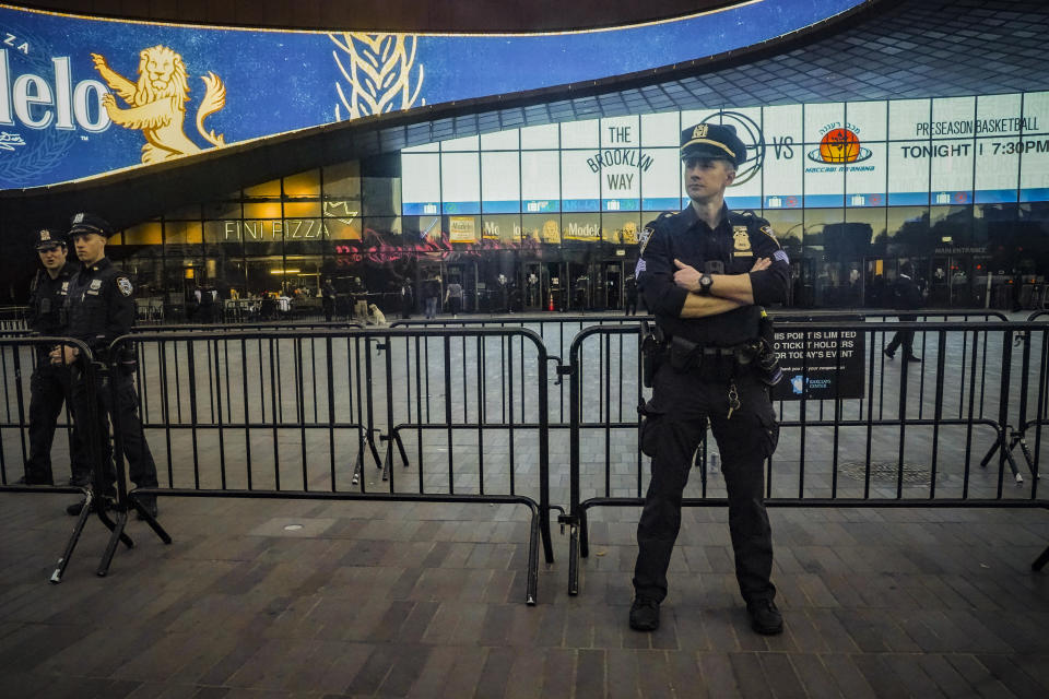 Police officers increase their presence at Barclays arena for a preseason NBA basketball game between the Brooklyn Nets and Israel's Maccabi Ra'anana, Thursday, Oct. 12, 2023, in New York. (AP Photo/Bebeto Matthews)