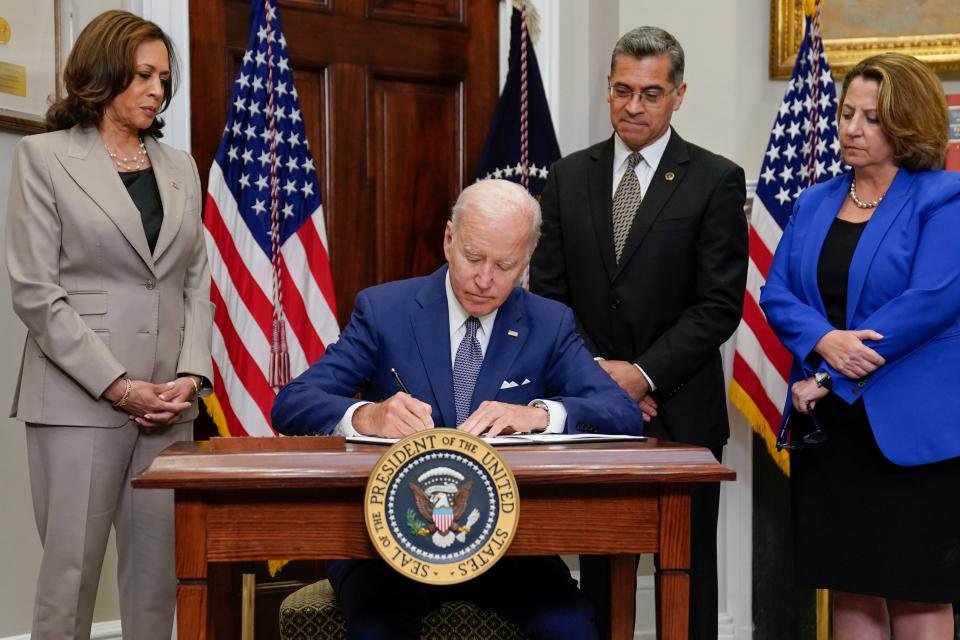 President Joe Biden signs an executive order on abortion access during an event in the Roosevelt Room of the White House, Friday, July 8, 2022, in Washington as Vice President Kamala Harris, Health and Human Services Secretary Xavier Becerra, and Deputy Attorney General Lisa Monaco watch.