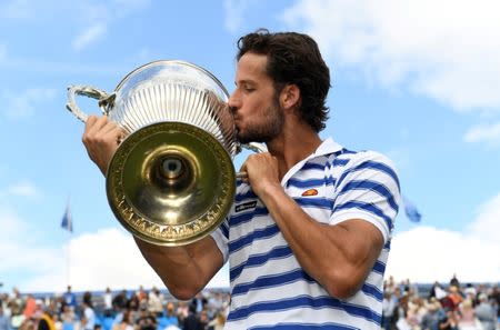 Tennis - Aegon Championships - Queen’s Club, London, Britain - June 25, 2017 Spain's Feliciano Lopez celebrates by kissing the trophy after winning the final against Croatia's Marin Cilic Action Images via Reuters/Tony O'Brien