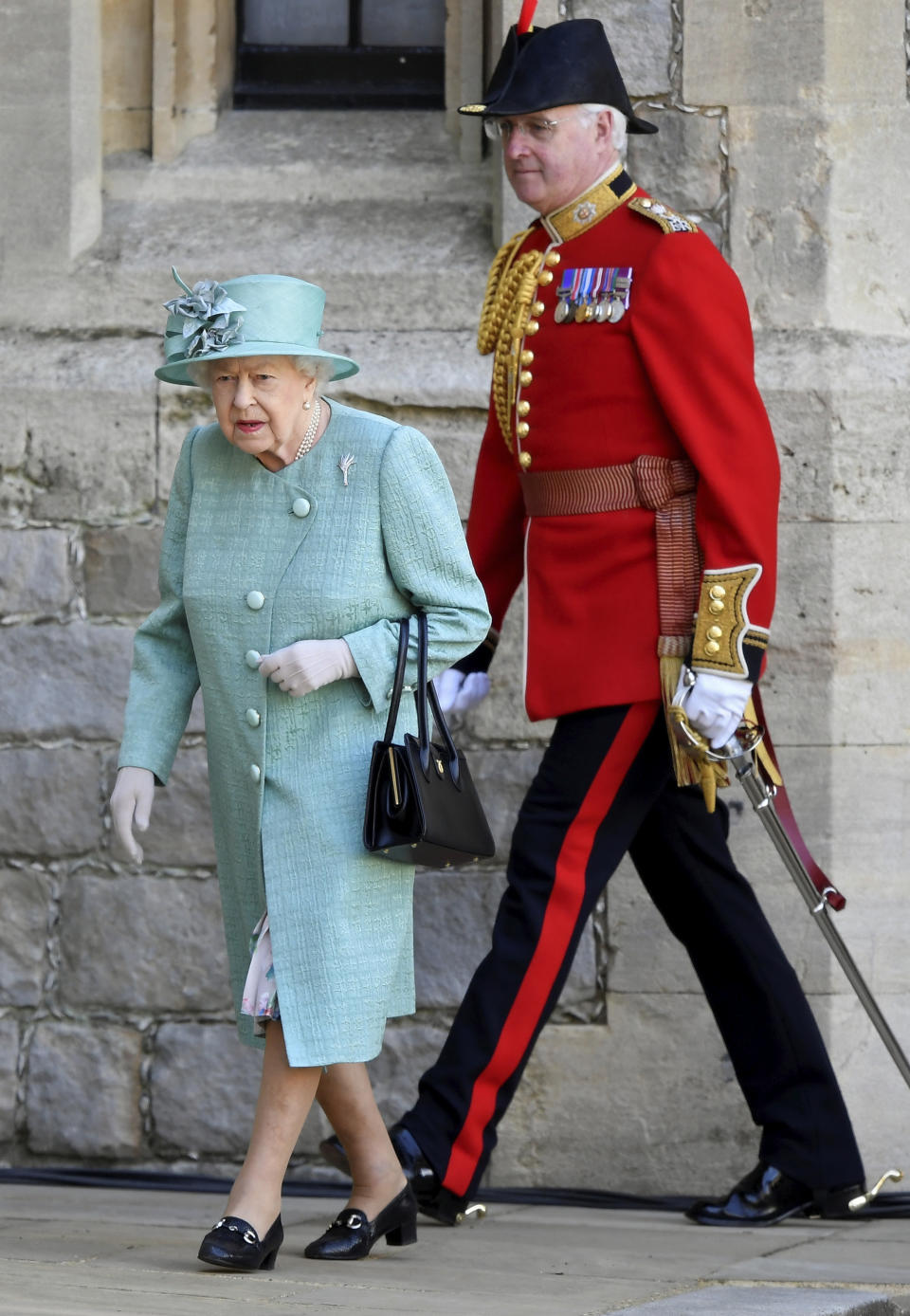 Britain's Queen Elizabeth II attends a ceremony to mark her official birthday at Windsor Castle in Windsor, England, Saturday June 13, 2020. Queen Elizabeth II’s birthday is being marked with a smaller ceremony than usual this year, as the annual Trooping the Color parade is canceled amid the coronavirus pandemic. The Queen celebrates her 94th birthday this year. (Toby Melville/Pool via AP)