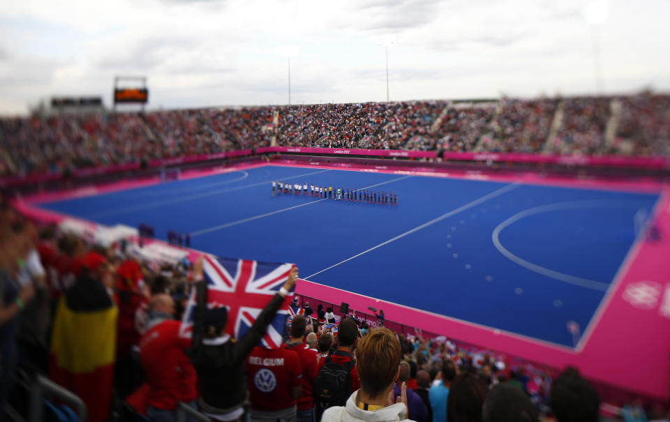 Britain and Argentina players line up before their men's Group A hockey match at the London 2012 Olympic Games at the Riverbank Arena on the Olympic Park in London July 30, 2012. Picture taken with a tilt-shift lens. REUTERS/Kai Pfaffenbach (BRITAIN - Tags: SPORT OLYMPICS SPORT FIELD HOCKEY) 