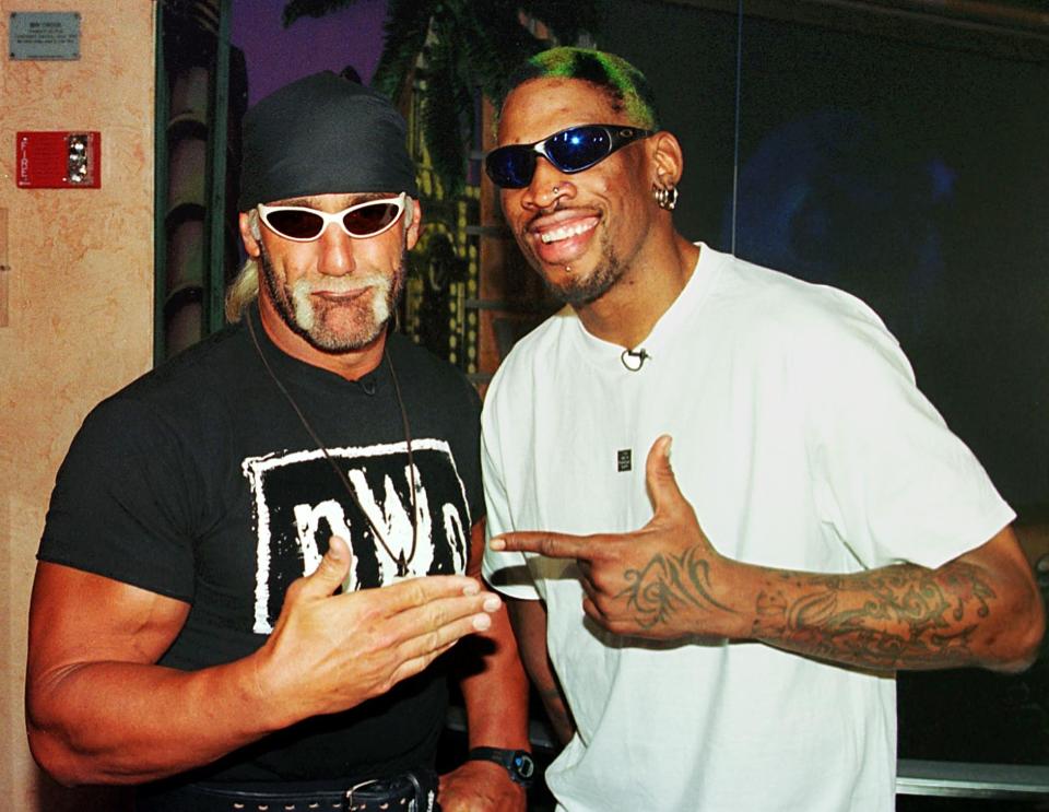 BEVERLY HILLS, UNITED STATES: Professional basketball player Dennis Rodman (R) of the Chicago Bulls poses with World Champion Professional wrestler Hollywood Hulk Hogan (L) following a press conference to announce 18 June that Karl Malone of the Utah Jazz and Rodman will wrestle each other in San Diego at the "Bash At The Beach" professional wrestling extravaganza 12 July. Rodman (aka Rodzilla) will be paired with Hogan and Malone's partner will be Diamond Dallas Page. AFP PHOTO Mike NELSON (Photo credit should read MIKE NELSON/AFP via Getty Images)