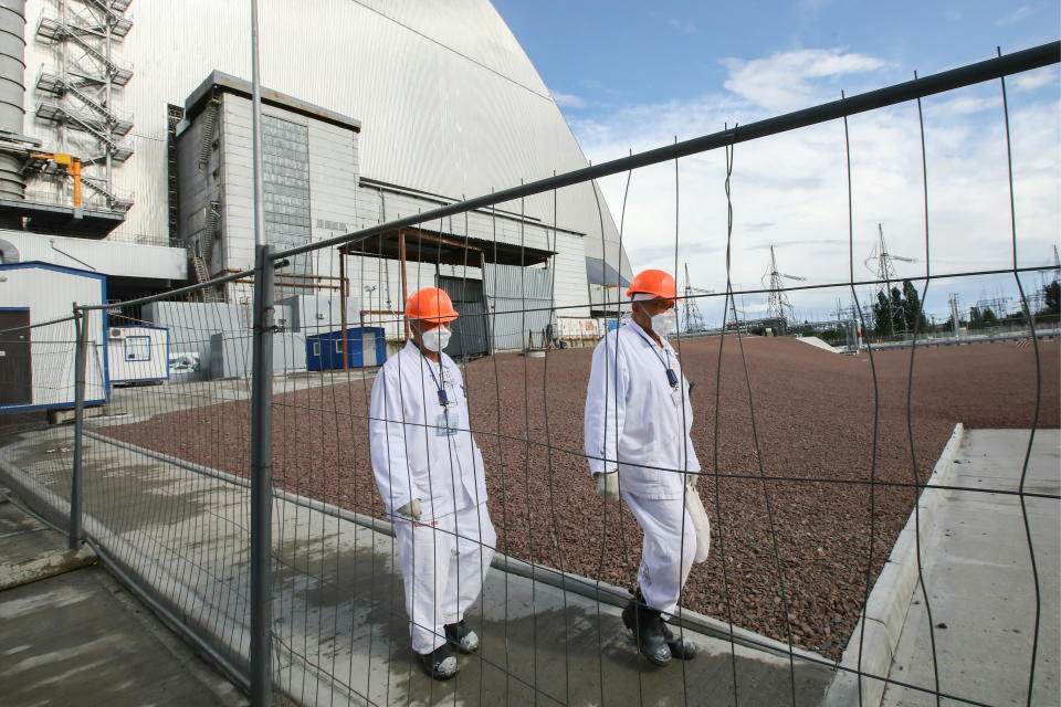 PRIPYAT, UKRAINE - JULY 10, 2019: Workers outside the new mobile metal structure, officially known as the New Safe Confinement, built over Reactor 4 of the Chernobyl Nuclear Power Plant, the new metal shelter has been officially handed over by the EU to the Ukrainian authorities; the construction of the 1.5bn euro metal shelter began in 2012; Reactor 4 is the site of the 1986 Chernobyl disaster. Pyotr Sivkov/TASS (Photo by Pyotr Sivkov\TASS via Getty Images)