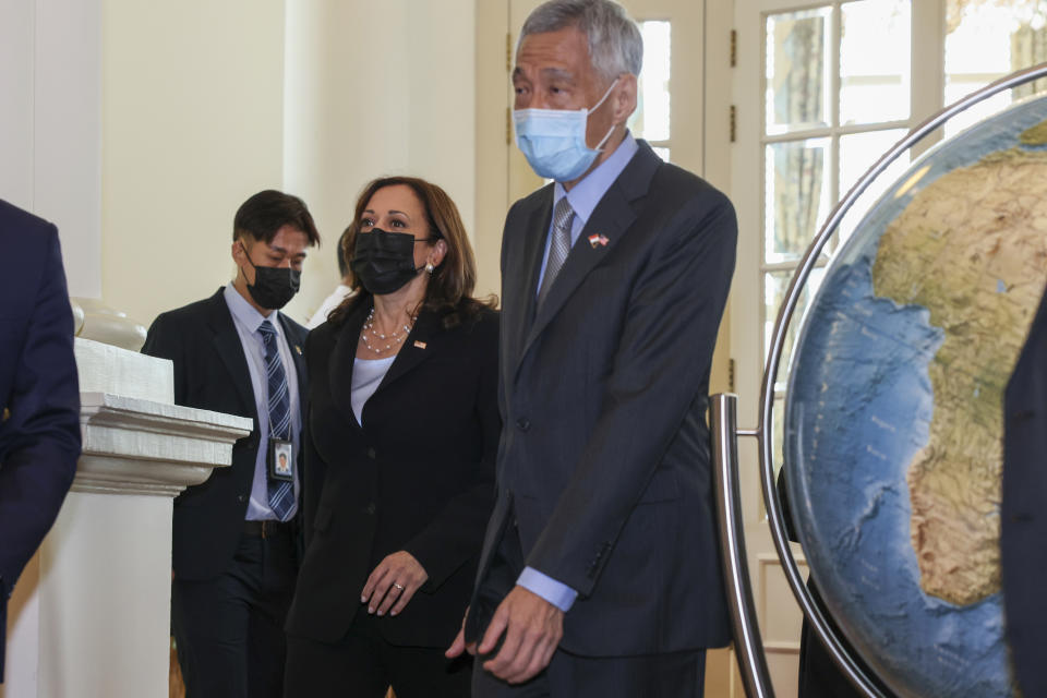 U.S. Vice President Kamala Harris, center, walks with Singapore's Prime Minister Lee Hsien Loong, right, to a bilateral meeting at the Istana in Singapore Monday, Aug. 23, 2021. (Evelyn Hockstein/Pool Photo via AP)