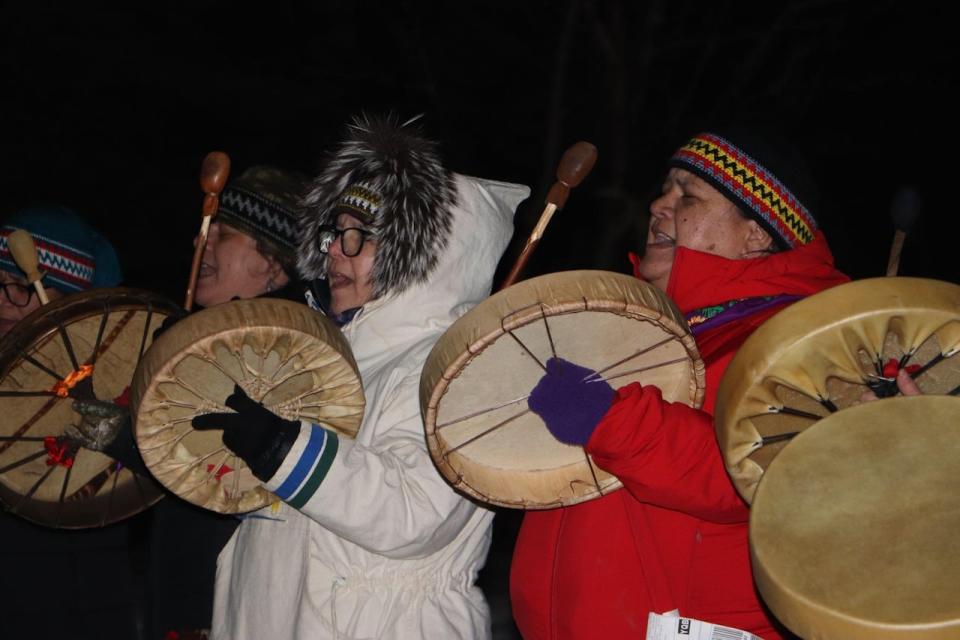 Drummers flank the snowmobile trail, preparing for the arrival of the participants. 