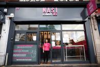 Mandy Yin poses inside Nasi Economy Rice, the takeaway shop she owns, amid the coronavirus disease (COVID-19) outbreak, in North London