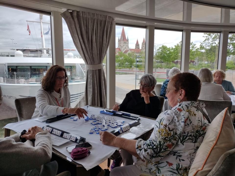 Cruisers play mahjong on a cruise organized by Crak Your Bags.