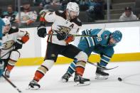 Anaheim Ducks center Adam Henrique (14) skates toward the puck next to San Jose Sharks defenseman Mario Ferraro (38) during the second period of an NHL hockey game in San Jose, Calif., Tuesday, Nov. 1, 2022. (AP Photo/Jeff Chiu)