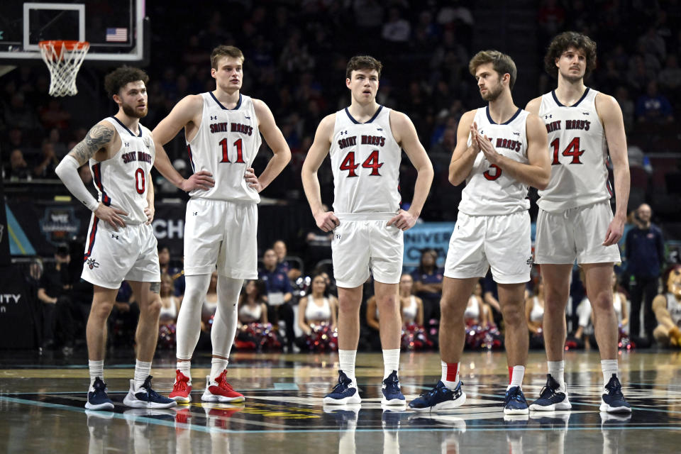 Saint Mary's guard Logan Johnson (0), center Mitchell Saxen (11), guard Alex Ducas (44), Saint Mary's guard Augustas Marciulionis (3) and Saint Mary's forward Kyle Bowen (14) stand at center court after a technical foul was called during the second half of an NCAA college basketball game against BYU in the semifinals of the West Coast Conference men's tournament Monday, March 6, 2023, in Las Vegas. (AP Photo/David Becker)