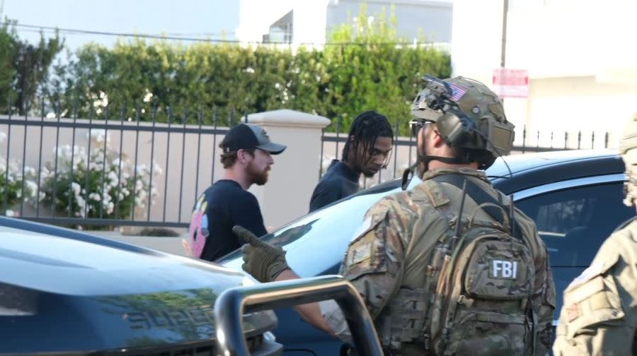 A male suspect was taken into custody during an FBI SWAT Team raid in Canoga Park on May 7, 2024. (TNLA)