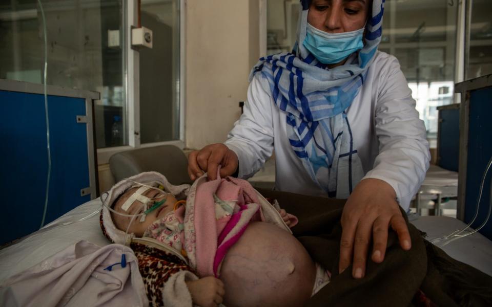 Nurse Susan Sahib Zada tends to five-month-old Zahra, who is being treated on the malnutrition ward at the Indira Ghani children's hopsital in Kabul - Stefanie Glinski