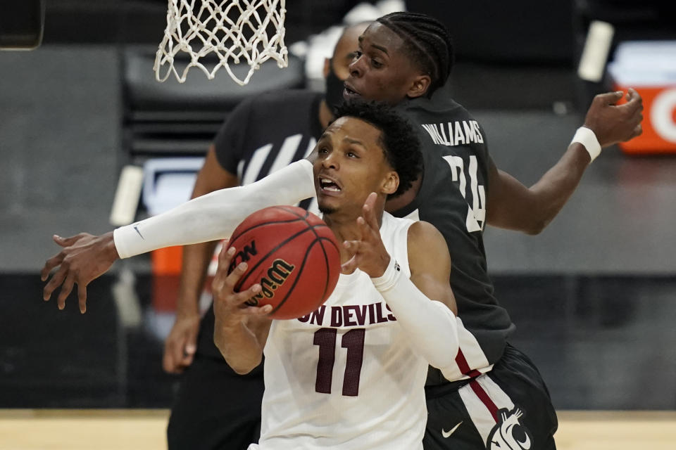 Arizona State's Alonzo Verge Jr. (11) shoots around Washington State's Noah Williams (24) during the second half of an NCAA college basketball game in the first round of the Pac-12 men's tournament Wednesday, March 10, 2021, in Las Vegas. (AP Photo/John Locher)