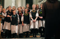 Shchedryk youth choir members listen to chief conductor Marianna Sablina following a Christmas concert at Copenhagen’s Church of the Holy Spirit, in Copenhagen, Denmark, Thursday, Dec. 8 2022. The Shchedryk ensemble, described as Kyiv’s oldest professional children’s choir, were in the Danish capital this week for a performance as part of an international tour that also took them to New York’s famed Carnegie Hall. (AP Photo/James Brooks)