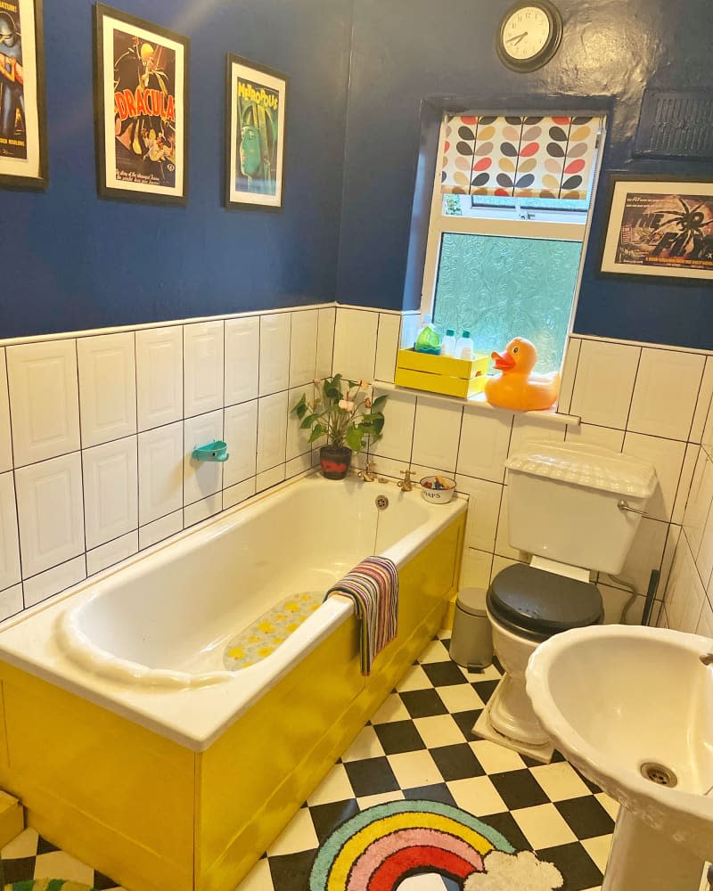 Yellow tub in bathroom before renovation.