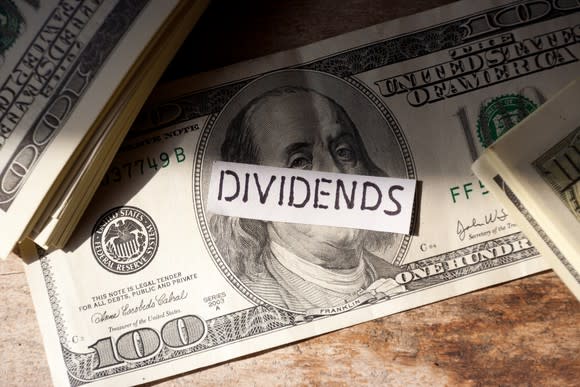 $100 bills with the word dividend on top.