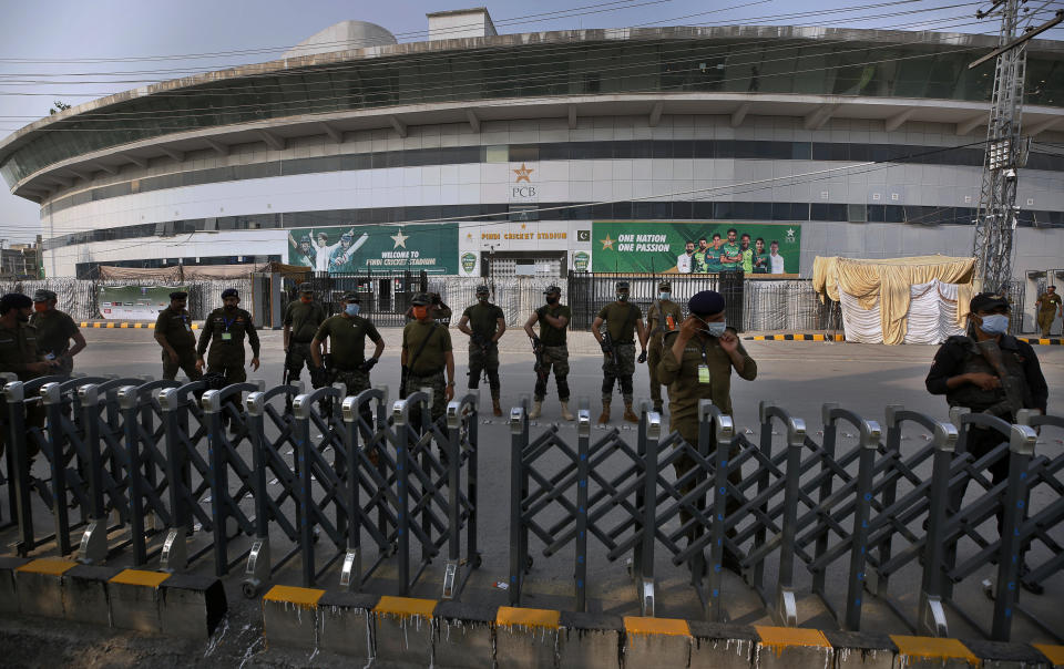 Pakistan paramilitary troops and police officer stand guard outside the Pindi Cricket Stadium following canceling of 1st one day international cricket match between Pakistan and New Zealand, in Rawalpindi, Pakistan, Friday, Sept. 17, 2021. New Zealand abandoned its cricket tour of Pakistan over security concerns that mystified the hosts, just before the Black Caps' first scheduled match in Pakistan in 18 years. (AP Photo/Anjum Naveed)