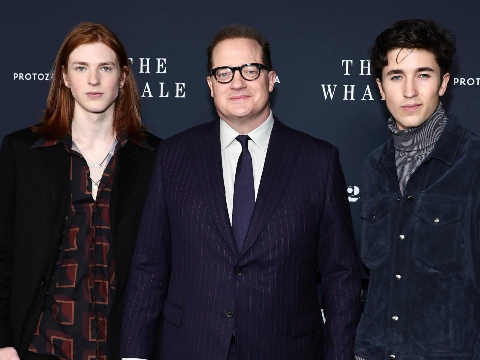 Leland Fraser and Holden Fraser pose with father Brendan Fraser in the middle during a red carpet for "The Whale."