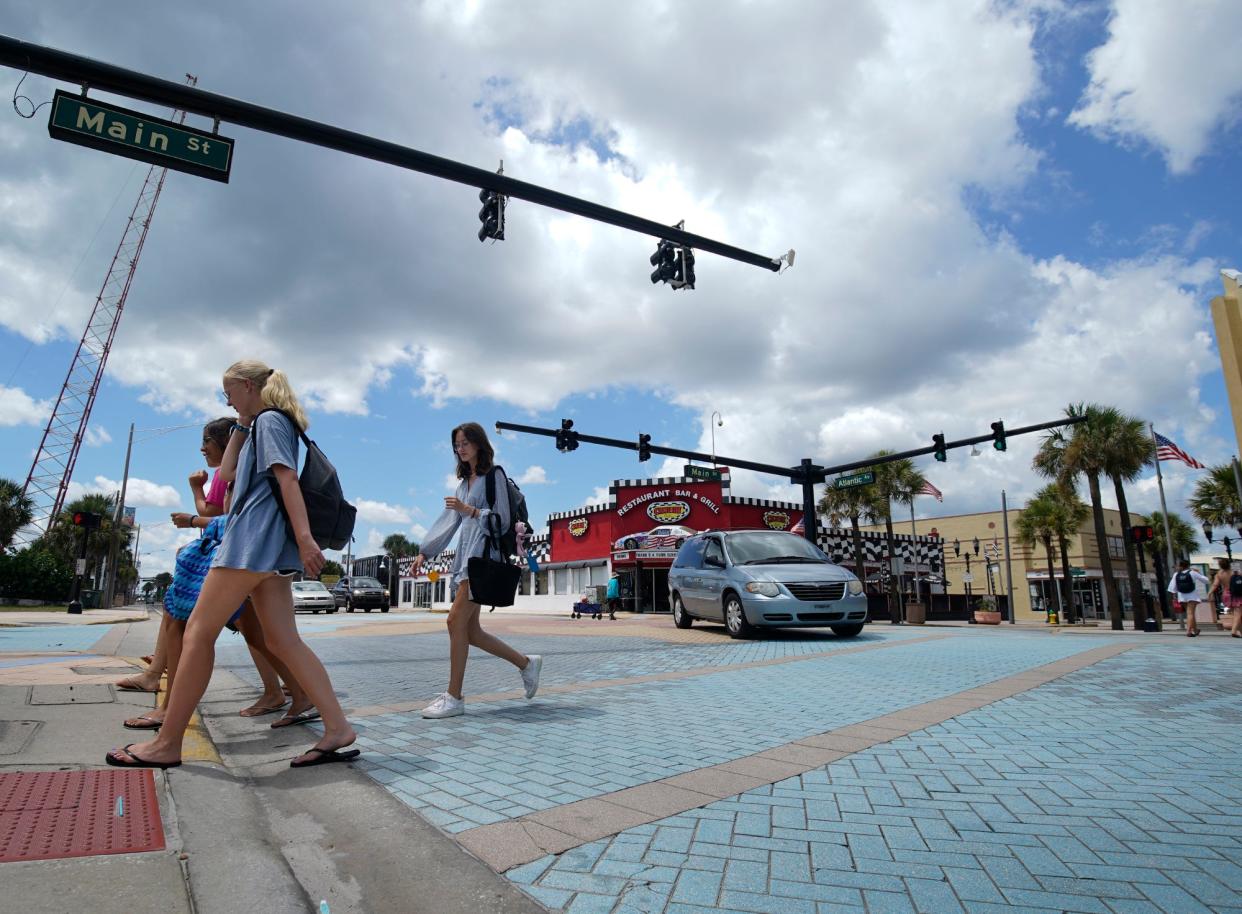 A group of pedestrians cross State Road A1A at Main Street in Daytona Beach on Monday, July 11, 2022. Sections of A1A are being studied for ways to slow traffic and improve safety conditions for people on foot and bicycles.