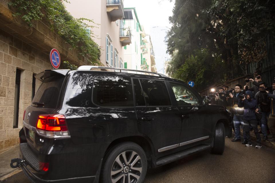 Journalists film a vehicle leaving the home of former Nissan Chairman Carlos Ghosn in Beirut, Lebanon, Thursday, Jan. 2, 2020. Turkish authorities have detained seven people as part of an investigation into how Ghosn, who skipped bail in Japan, was able to flee to Lebanon via Istanbul, Turkish media reported Thursday. (AP Photo/Maya Alleruzzo)