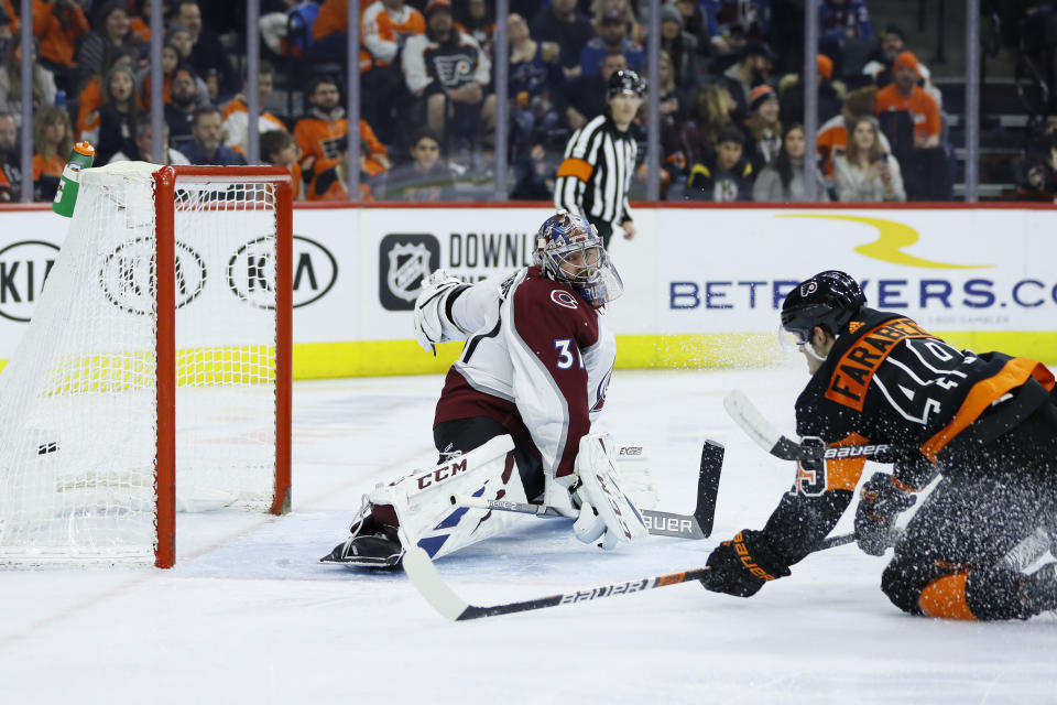 Philadelphia Flyers' Joel Farabee, right, scores a goal past Colorado Avalanche's Philipp Grubauer during the second period of an NHL hockey game, Saturday, Feb. 1, 2020, in Philadelphia. (AP Photo/Matt Slocum)