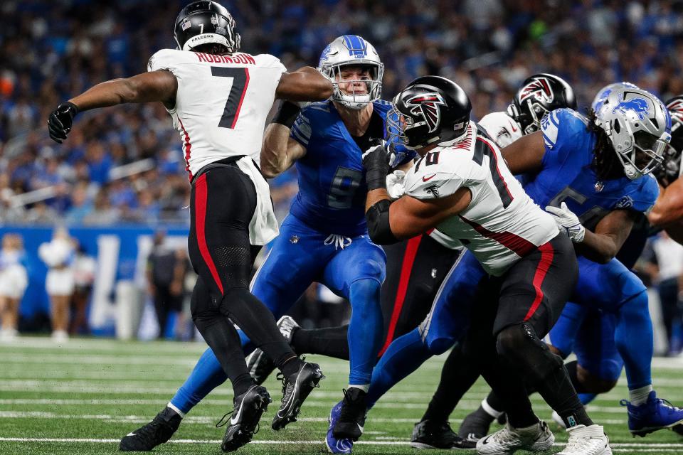 Detroit Lions defensive end Aidan Hutchinson (97) is blocked by Atlanta Falcons running back Bijan Robinson (7) and offensive tackle Jake Matthews (70) during the second half at Ford Field in Detroit on Sunday, Sept. 24, 2023.