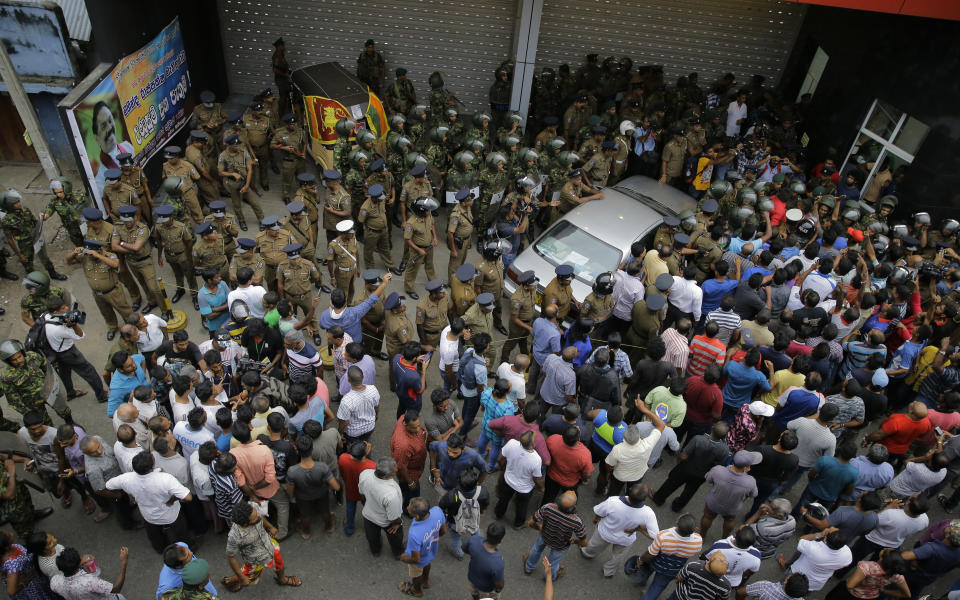 Sri Lankan security forces are deployed near the petroleum ministry building in Colombo, Sri Lanka, Sunday, Oct. 28, 2018. Arjuna Ranatunga who was petroleum minister under Wickremesinghe said one of his security guards opened fire when Rajapaksa supporters mobbed him and protested against him entering the ministry premises. (AP Photo/Eranga Jayawardena)
