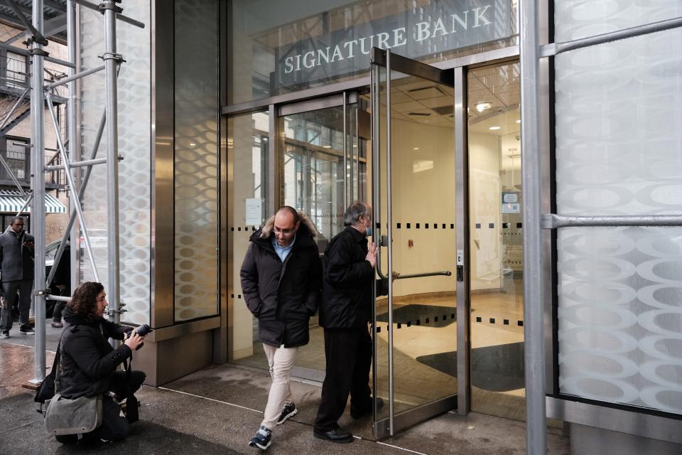 A man walks out of a Manhattan branch of Signature Bank, which was closed by bank regulators on March 13.