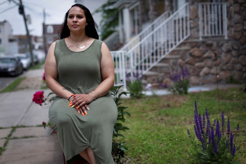 Gabby Niziolek poses for a photograph in front of her home in Elizabeth, New Jersey