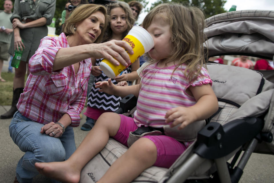 <p>Republican presidential candidate Carly Fiorina shares her "diabetic lemonade" with Teresa Tehoke, 2, as her sister, Maire, 6, watches.</p>