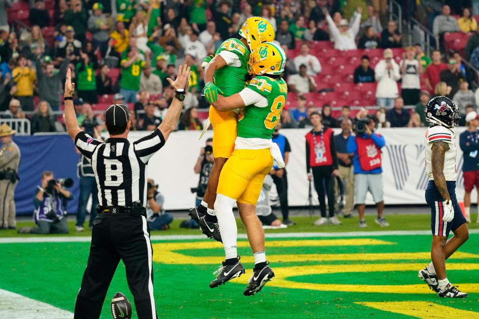 Oregon wide receiver Gary Bryant Jr., left, celebrates his touchdown during the first half on the NCAA Fiesta Bowl college football game against Liberty, Monday, Jan. 1, 2024, in Glendale, Ariz.