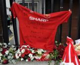 Floral tributes are laid for the Liverpool fans who died at Hillsborough Stadium, during the FA cup semi-final between Liverpool and Nottingham Forest in 1989, outside the Anfield Hillsborough memorial, prior to the English Premier League soccer match between Liverpool and Manchester United, at Anfield in Liverpool, England, Sunday Sept. 23, 2012. (AP Photo/Clint Hughes)