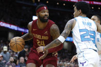 Cleveland Cavaliers forward Marcus Morris Sr. (24) drives against Charlotte Hornets guard Tre Mann (23) during the first half of an NBA basketball game, Monday, March 25, 2024, in Cleveland. (AP Photo/Ron Schwane)