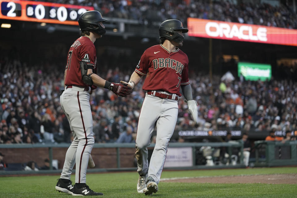 Arizona Diamondbacks' Corbin Carroll, right, celebrates with Jake McCarthy after scoring against the San Francisco Giants on Lourdes Gurriel Jr.'s double during the sixth inning of a baseball game Monday, July 31, 2023, in San Francisco. (AP Photo/Godofredo A. Vásquez)