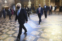 Britain's Prime Minister Boris Johnson, left, and Labour Party leader Keir Starmer, second left, walk through the Central Lobby on the way to the House of Lords prior to Queen Elizabeth II delivering a speech during the State Opening of Parliament in the House of Lords at the Palace of Westminster in London, Tuesday May 11, 2021. (Stefan Rousseau/Pool via AP)