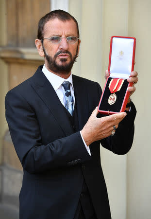 Ringo Starr, whose real name is Richard Starkey, poses after receiving his Knighthood at an Investiture ceremony at Buckingham palace in London, Britain, March 20, 2018. John Stillwell/Pool via Reuters