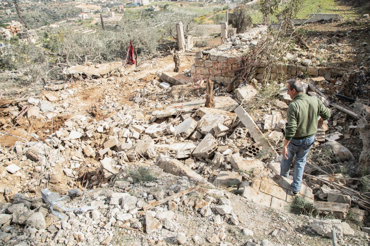 A man checks the destruction following an Israeli airstrike the previous day on the village of Taybeh near the border with Israel in southern Lebanon, on 15 February 2024 (AFP via Getty Images)