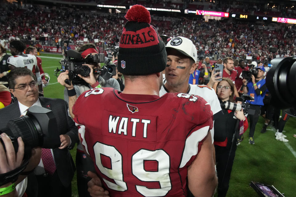 Tampa Bay Buccaneers quarterback Tom Brady greets Arizona Cardinals defensive end J.J. Watt (99) after an NFL football game, Sunday, Dec. 25, 2022, in Glendale, Ariz. The Buccaneers defeated the Cardinals 19-16 in overtime. (AP Photo/Rick Scuteri)