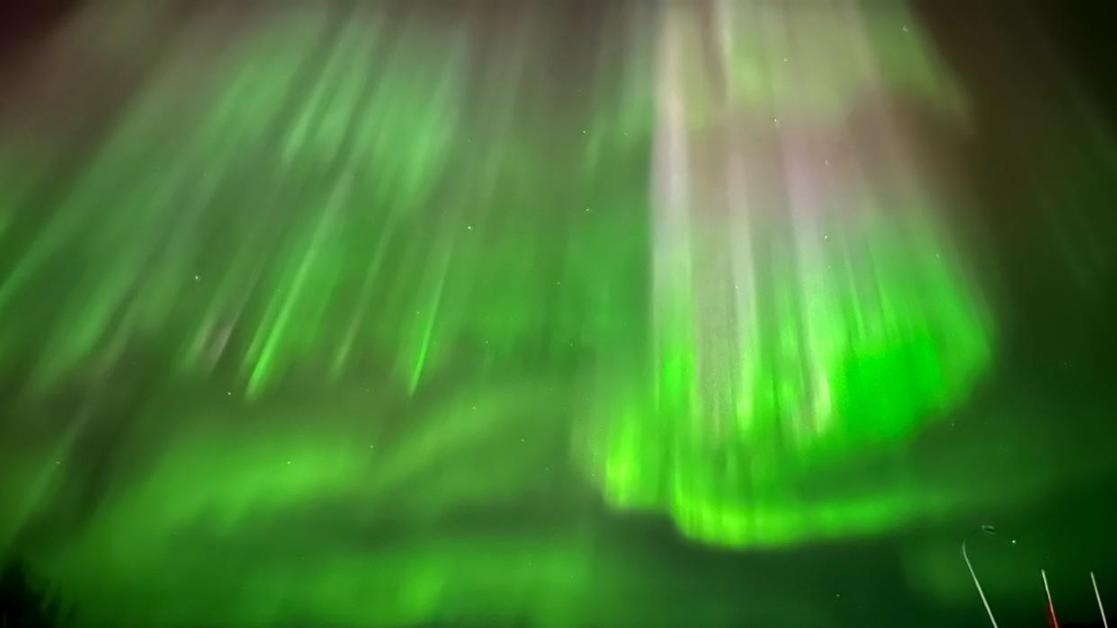  Green and yellow auroras in the sky. 