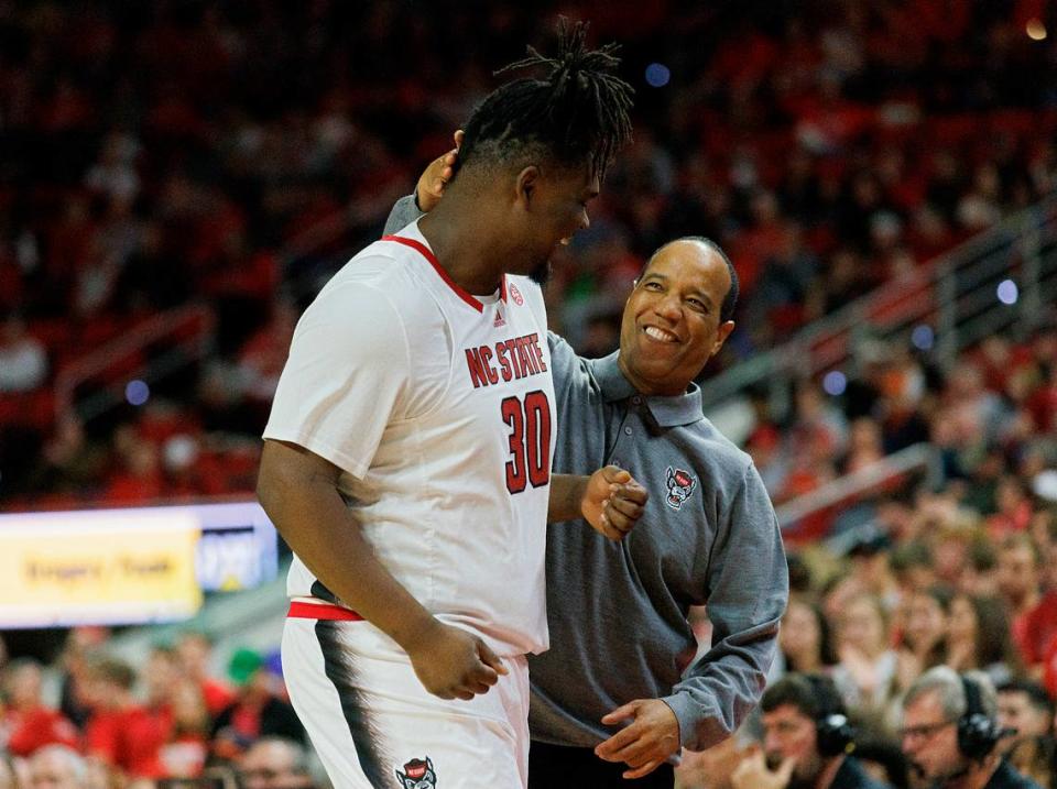 N.C. State head coach Kevin Keatts smiles as DJ Burns Jr. heads to the bench late in the second half of the Wolfpack’s 76-60 win over Virginia on Saturday, Jan. 6, 2024, at PNC Arena in Raleigh, N.C.