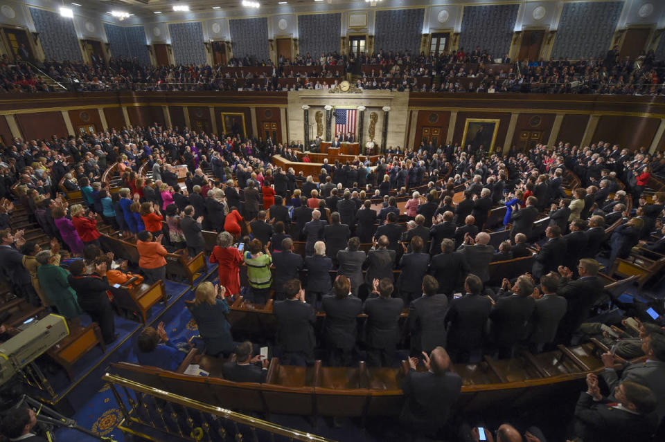 Members of Congress stand and applaud