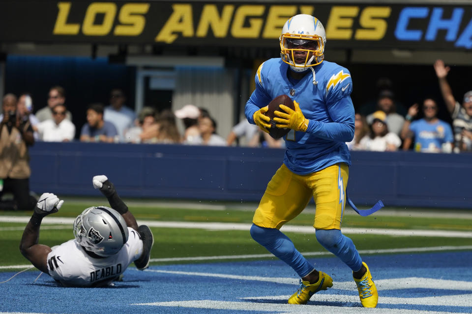 Los Angeles Chargers wide receiver DeAndre Carter, right, reacts after catching a touchdown pass next to Las Vegas Raiders linebacker Divine Deablo (5) during the first half of an NFL football game in Inglewood, Calif., Sunday, Sept. 11, 2022. (AP Photo/Marcio Jose Sanchez)