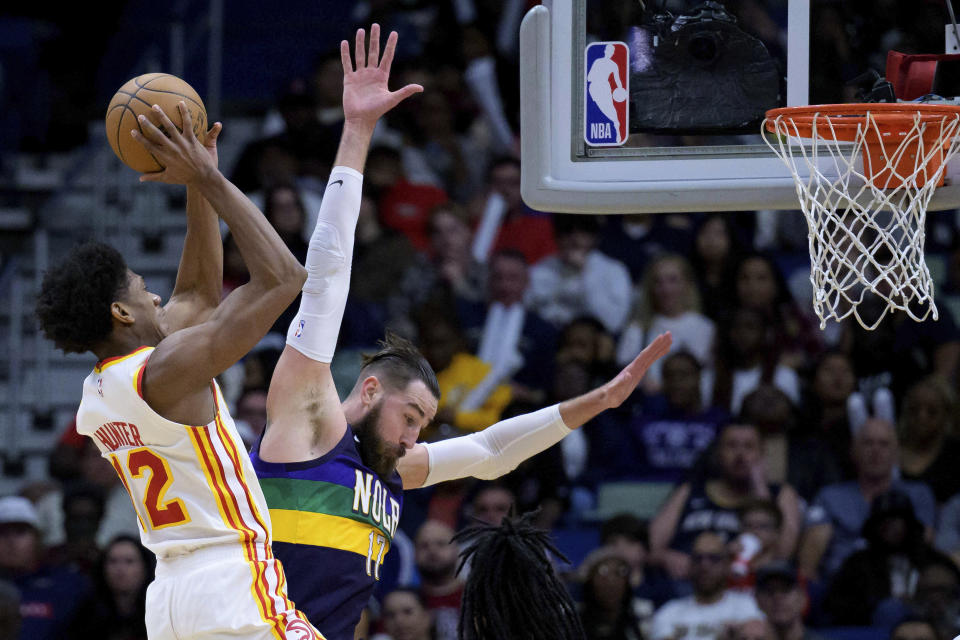 Atlanta Hawks forward De'Andre Hunter (12) shoots against New Orleans Pelicans center Jonas Valanciunas (17) during the first half of an NBA basketball game in New Orleans, Tuesday, Feb. 7, 2023. (AP Photo/Matthew Hinton)