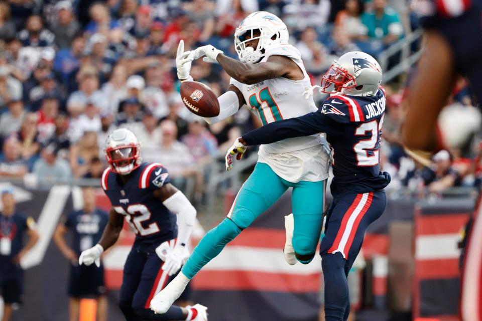 DeVante Parker, shown attempting to make a catch against ex-New England cornerback J.C. Jackson, will be wearing Patriots colors the next time the Dolphins and Patriots meet.