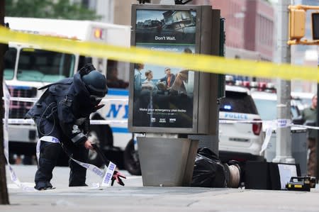 A NYPD Bomb Squad officer investigates suspicious packages near West 16th Street and Seventh Avenue as police were investigating suspicious packages in Manhattan
