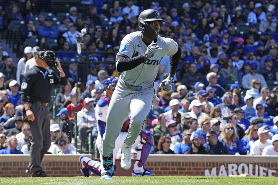 Miami Marlins' Jesús Sánchez, center, runs after hitting a one-run single during the fourth inning of a baseball game against the Chicago Cubs in Chicago, Sunday, April 21, 2024. (AP Photo/Nam Y. Huh)